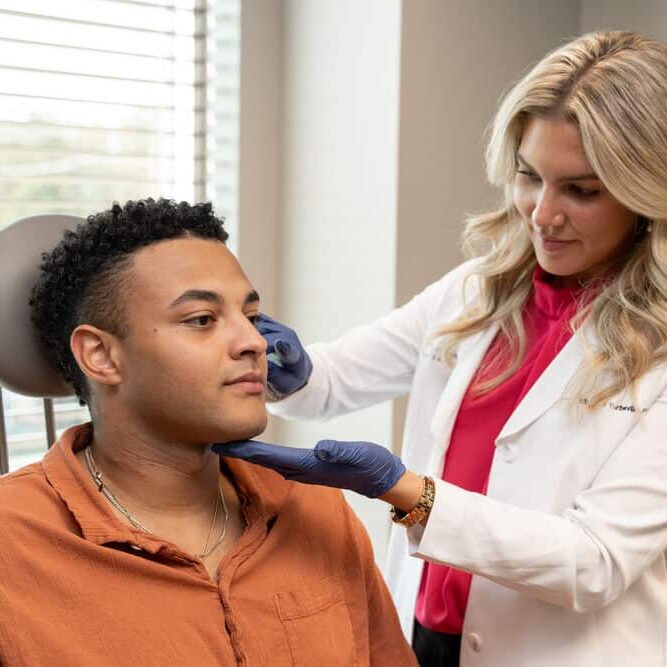 Liz Turbevile examining dermatology patient